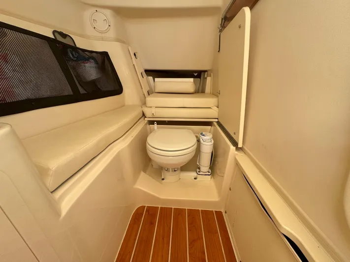Bay Tripper Yacht Photos Pics 2019 Grady-White Freedom 307 boat interior with toilet and seating area.