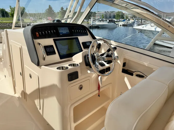Bay Tripper Yacht Photos Pics 2019 Grady-White Freedom 307 boat cockpit with steering wheel and navigation system.