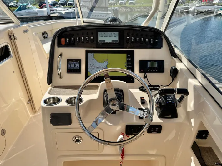 Bay Tripper Yacht Photos Pics 2019 Grady-White Freedom 307 boat dashboard with steering wheel and navigation controls.