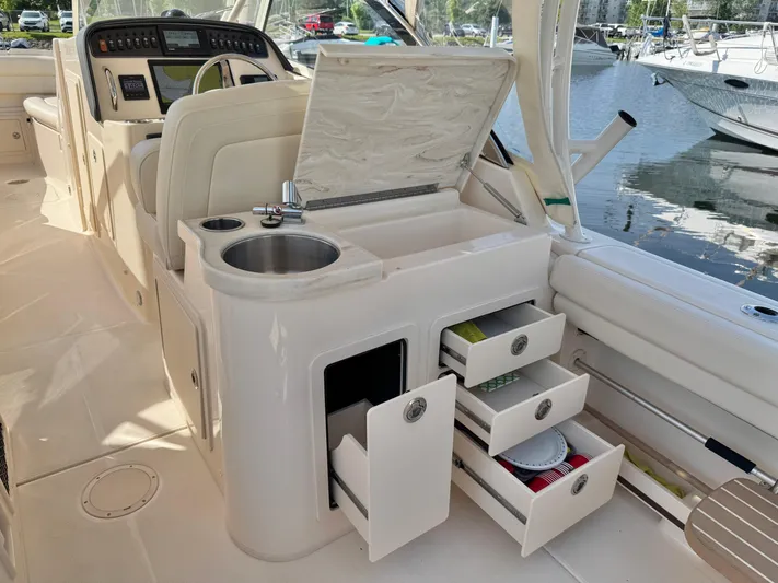 Bay Tripper Yacht Photos Pics 2019 Grady-White Freedom 307 boat interior with sink, storage drawers, and control panel.