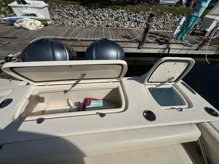 Bay Tripper Yacht Photos Pics 2019 Grady-White Freedom 307 boat with open storage compartments at dock.