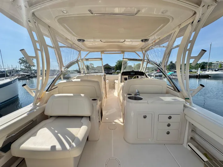 Bay Tripper Yacht Photos Pics 2019 Grady-White Freedom 307 boat interior with seating and helm, docked at marina.