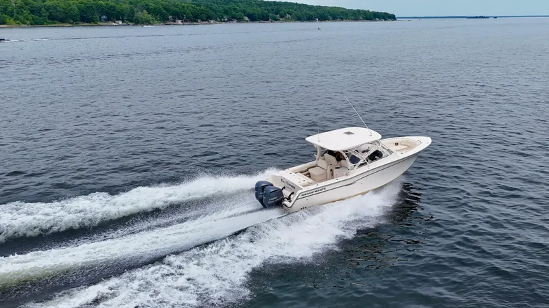 Bay Tripper Yacht Photos Pics 2019 Grady-White Freedom 307 cruising on open water, creating a wake.