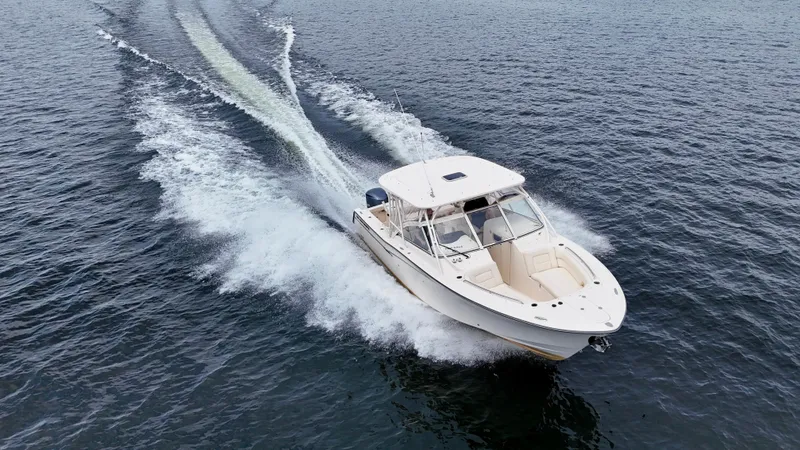 Bay Tripper Yacht Photos Pics 2019 Grady-White Freedom 307 cruising on open water, creating a dynamic wake.