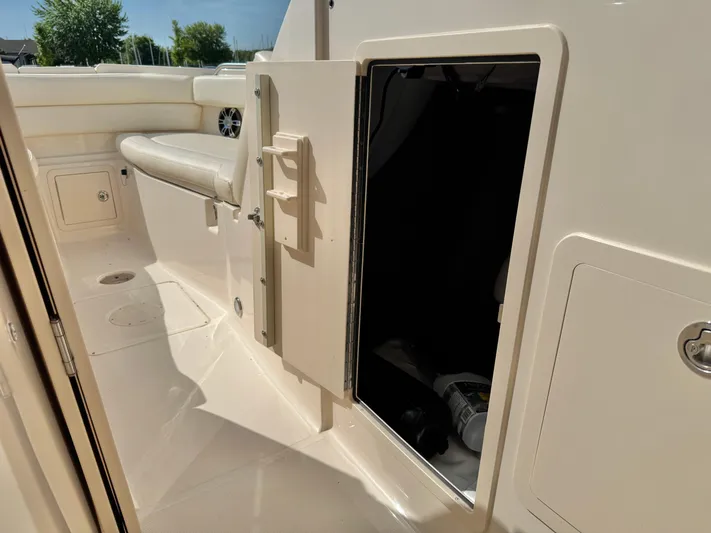 Bay Tripper Yacht Photos Pics 2019 Grady-White Freedom 307 boat interior with open storage compartment and seating.