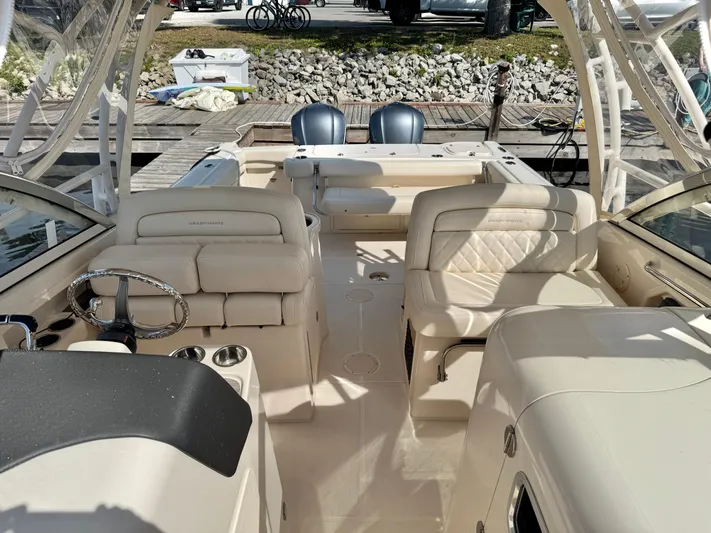 Bay Tripper Yacht Photos Pics 2019 Grady-White Freedom 307 boat interior with luxurious seating and steering wheel.