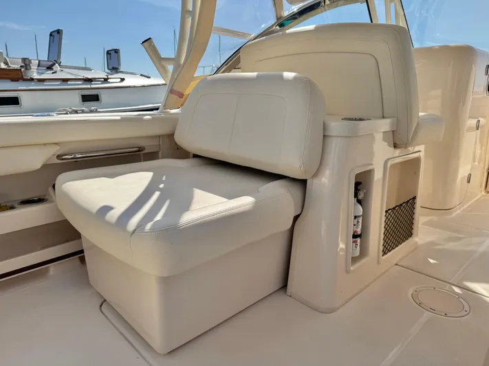 Bay Tripper Yacht Photos Pics 2019 Grady-White Freedom 307 boat interior with white seating and storage compartments.