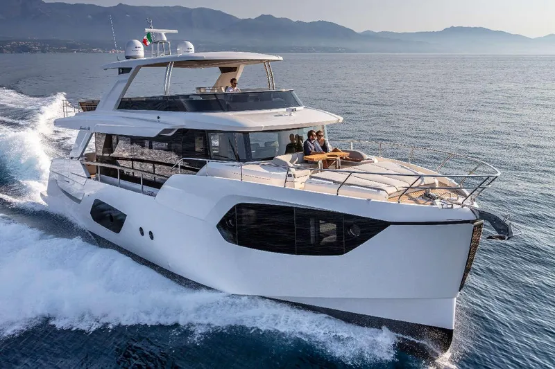  Yacht Photos Pics 2026 Absolute Navetta 68 yacht cruising on open water with passengers enjoying the view.