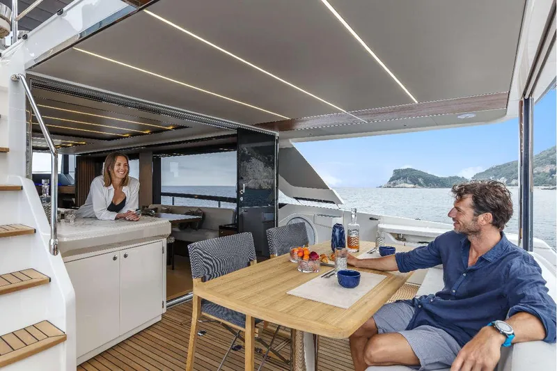  Yacht Photos Pics Couple enjoying leisure time on Absolute Navetta 68 yacht, 2026 model, with ocean view.