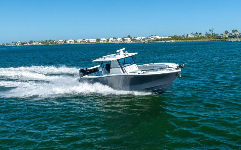  Yacht Photos Pics 2023 Yellowfin 42 boat cruising on a sunny day in coastal waters.
