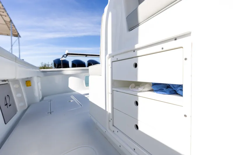 Yacht Photos Pics 2023 Yellowfin 42 boat interior with storage compartments and outboard motors.