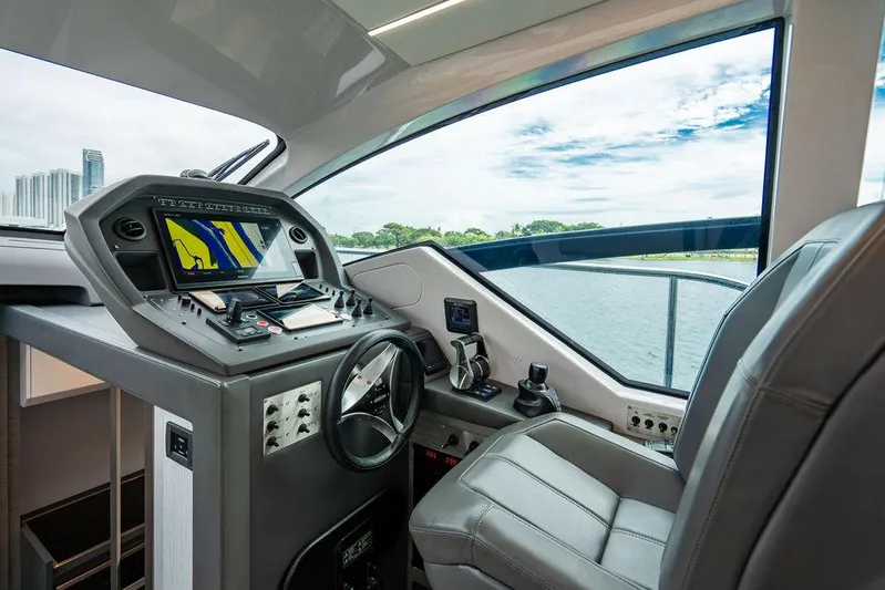 Two Bite Yacht Photos Pics Interior cockpit of 2018 Pershing 5x yacht with modern navigation controls.