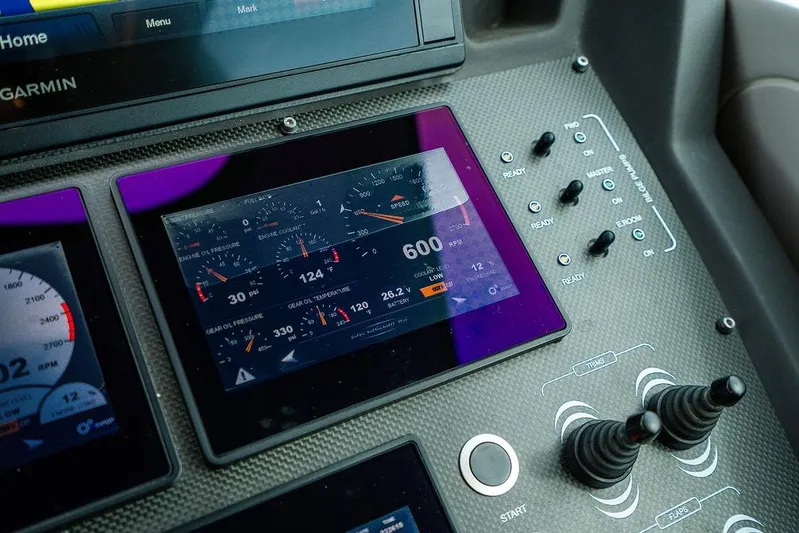 Two Bite Yacht Photos Pics Control panel of a 2018 Pershing 5x yacht with digital displays and switches.
