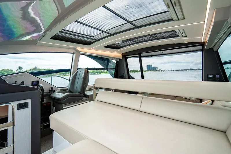 Two Bite Yacht Photos Pics Luxurious interior of 2018 Pershing 5x yacht with panoramic windows and modern seating.