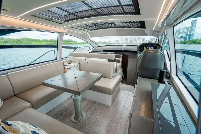 Two Bite Yacht Photos Pics Luxurious interior of 2018 Pershing 5x yacht with modern seating and panoramic windows.