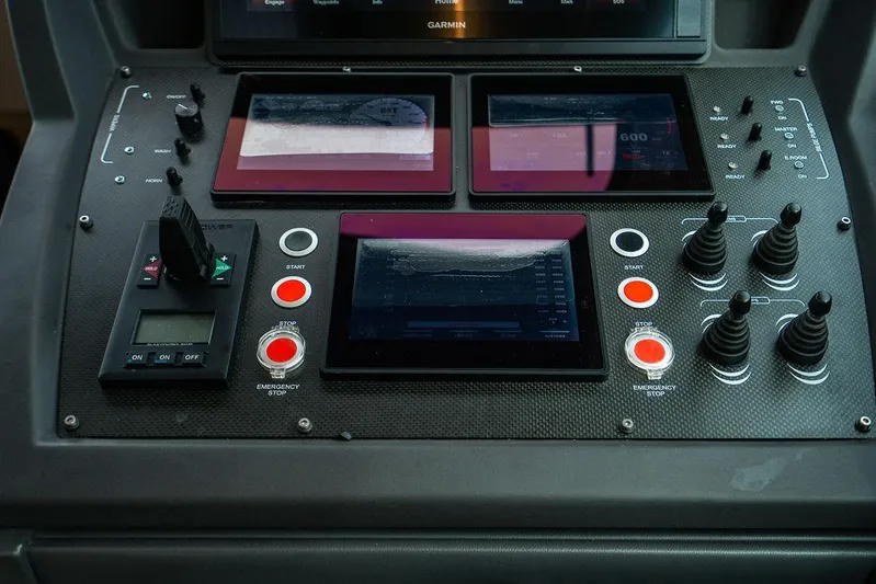 Two Bite Yacht Photos Pics Control panel of a 2018 Pershing 5x yacht with screens and buttons.