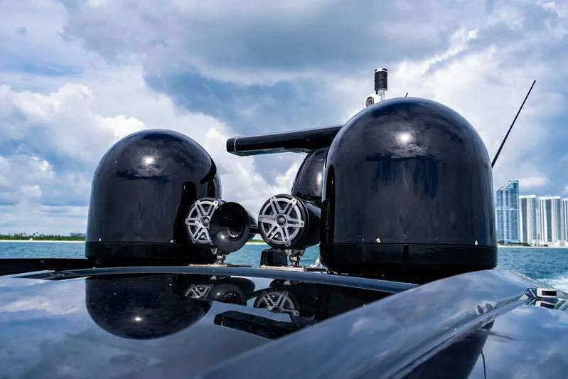 Two Bite Yacht Photos Pics Rooftop view of 2018 Pershing 5x yacht with radar domes against a cloudy sky.