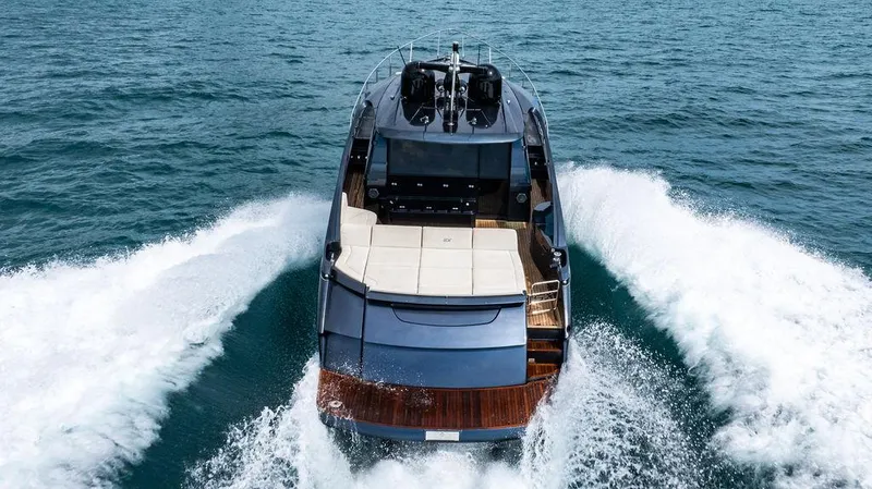 Two Bite Yacht Photos Pics 2018 Pershing 5x yacht cruising on open water, rear view.