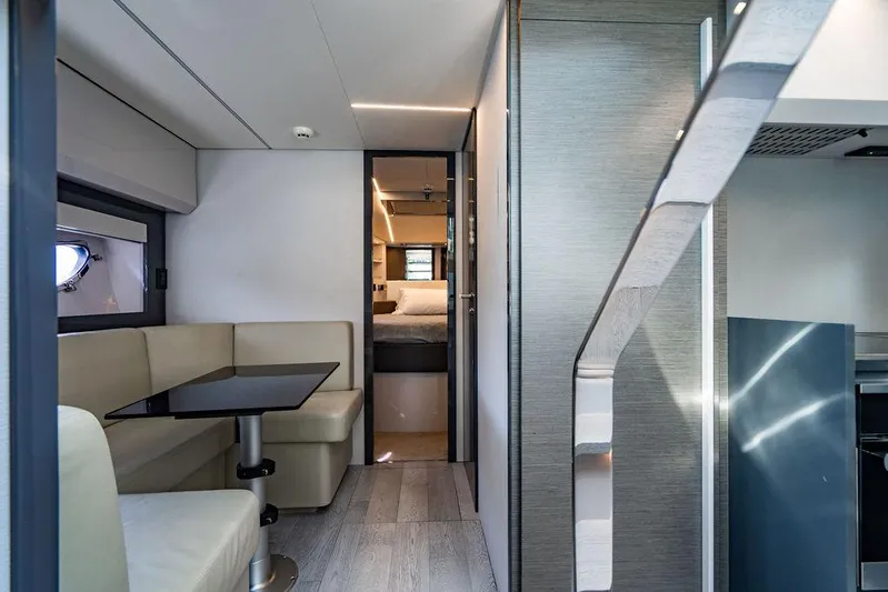 Two Bite Yacht Photos Pics Interior of 2018 Pershing 5x yacht, featuring modern seating and sleek design elements.