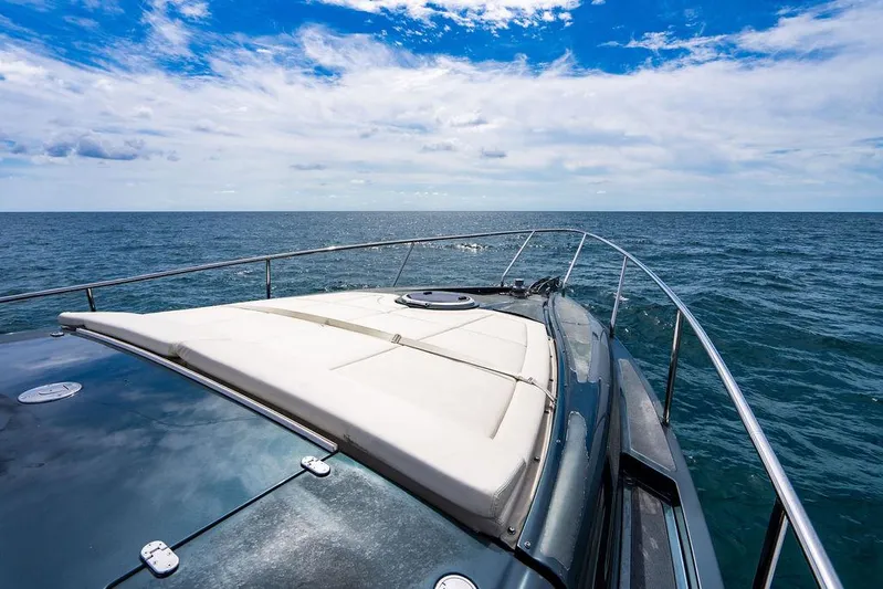 Two Bite Yacht Photos Pics 2018 Pershing 5x yacht cruising on open sea under a partly cloudy sky.