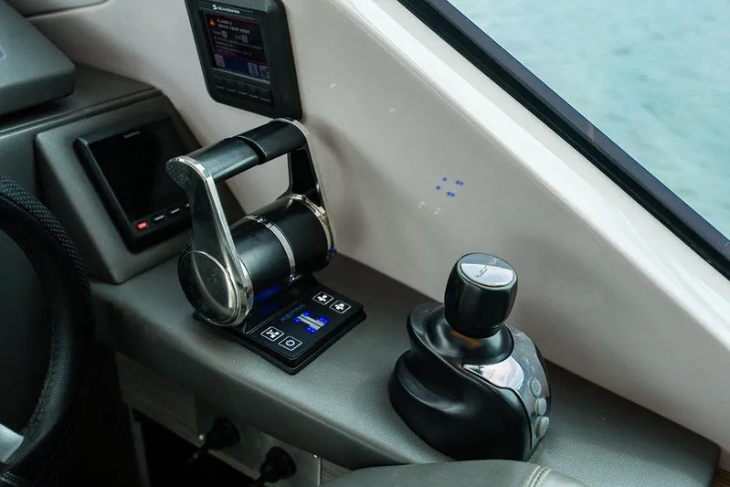 Two Bite Yacht Photos Pics Control panel of a 2018 Pershing 5x yacht, featuring throttle and joystick controls.
