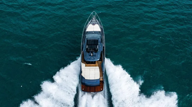 Two Bite Yacht Photos Pics 2018 Pershing 5x yacht cruising on open water, aerial view.