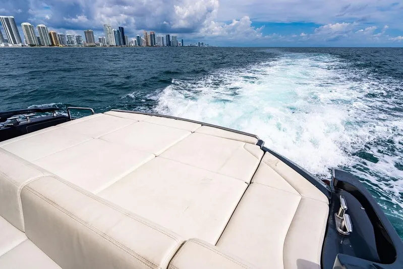 Two Bite Yacht Photos Pics 2018 Pershing 5x yacht cruising with city skyline in the background.