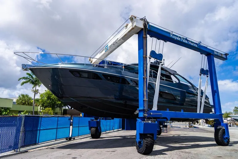 Two Bite Yacht Photos Pics 2018 Pershing 5x yacht on a blue boat lift at Royal Palm Marina.