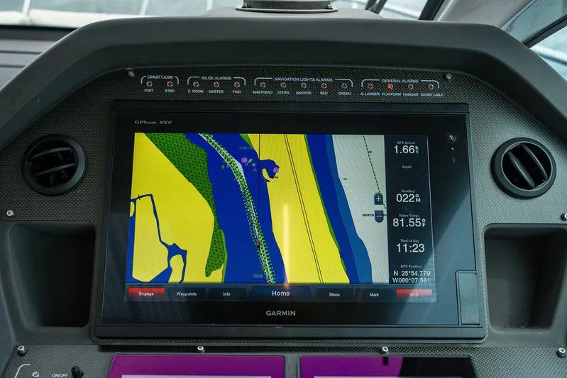 Two Bite Yacht Photos Pics Garmin navigation display on 2018 Pershing 5x yacht dashboard, showing colorful map interface.