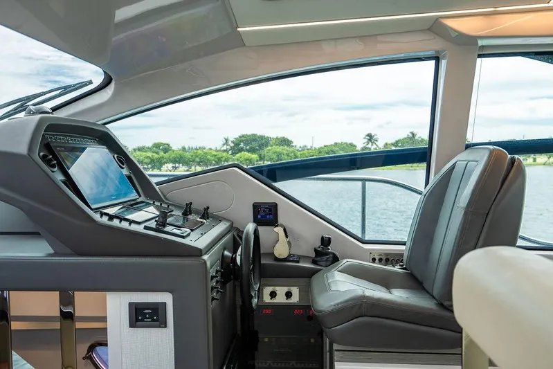 Two Bite Yacht Photos Pics Cockpit of 2018 Pershing 5x yacht with modern controls and leather seating.