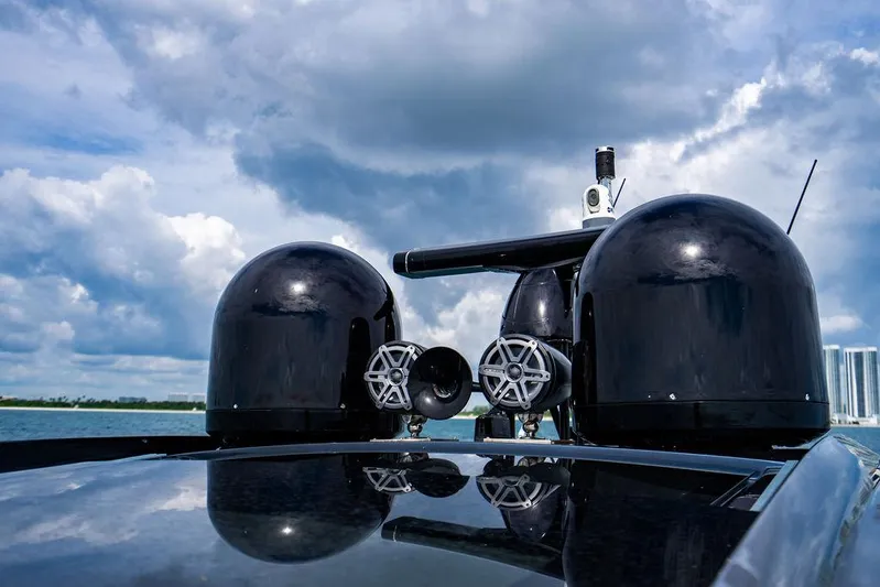 Two Bite Yacht Photos Pics 2018 Pershing 5x yacht with sleek black radar domes under cloudy sky.