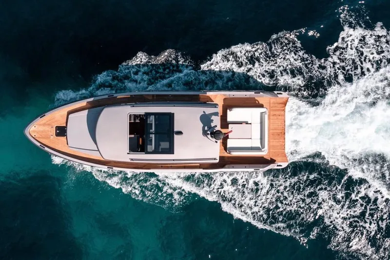  Yacht Photos Pics Aerial view of 2026 Glacier 48 yacht cruising on clear blue water.