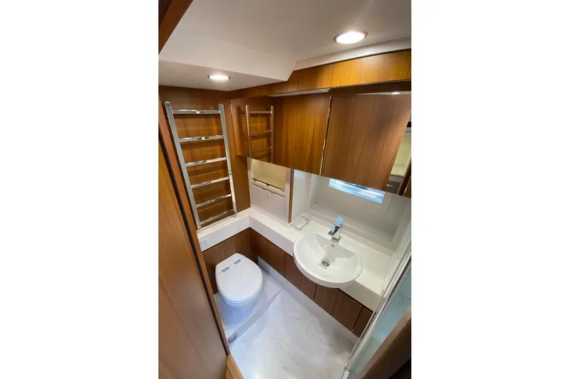  Yacht Photos Pics Modern bathroom in 2026 Glacier 48 yacht with wood accents and sleek fixtures.