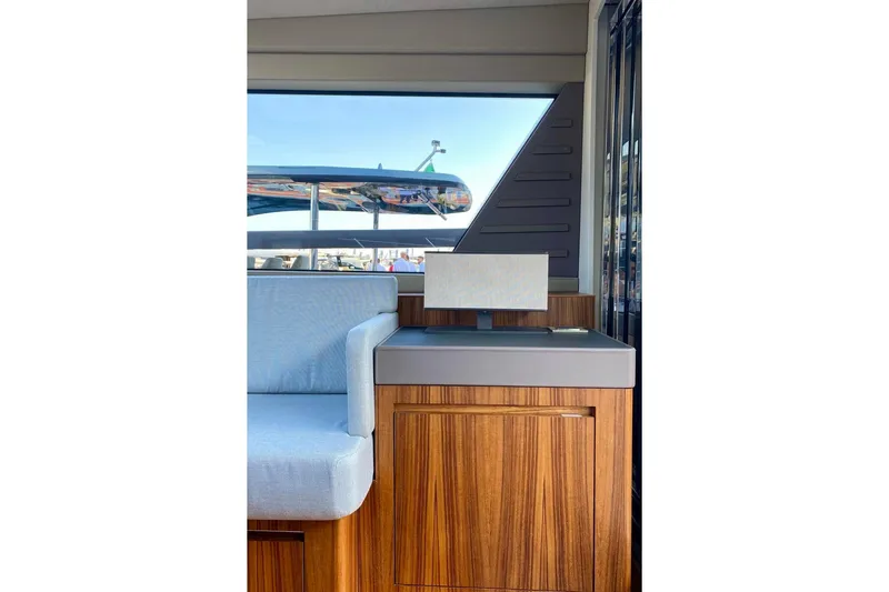  Yacht Photos Pics Interior of Glacier 48 yacht, featuring sleek wood cabinetry and modern seating, 2026 model.