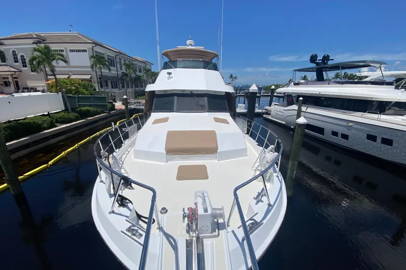  Yacht Photos Pics 1991 Hatteras 70 Motor Yacht docked at marina under clear blue sky.