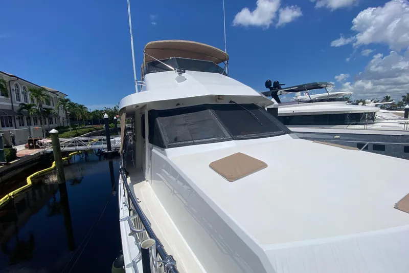  Yacht Photos Pics 1991 Hatteras 70 Motor Yacht docked under clear blue sky.