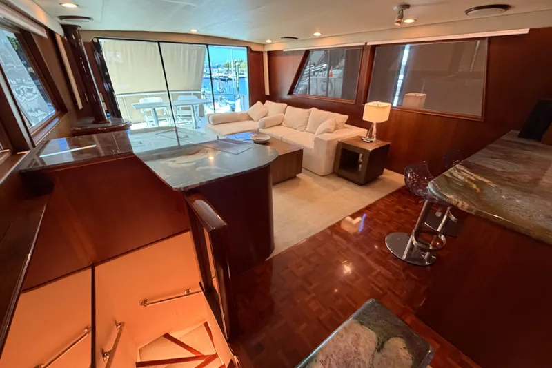  Yacht Photos Pics Luxurious interior of 1991 Hatteras 70 Motor Yacht with elegant wood finishes and modern furnishings.