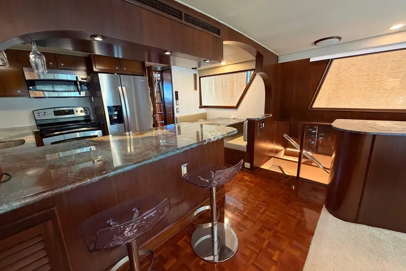  Yacht Photos Pics Luxurious interior of a 1991 Hatteras 70 Motor Yacht with modern kitchen and seating area.