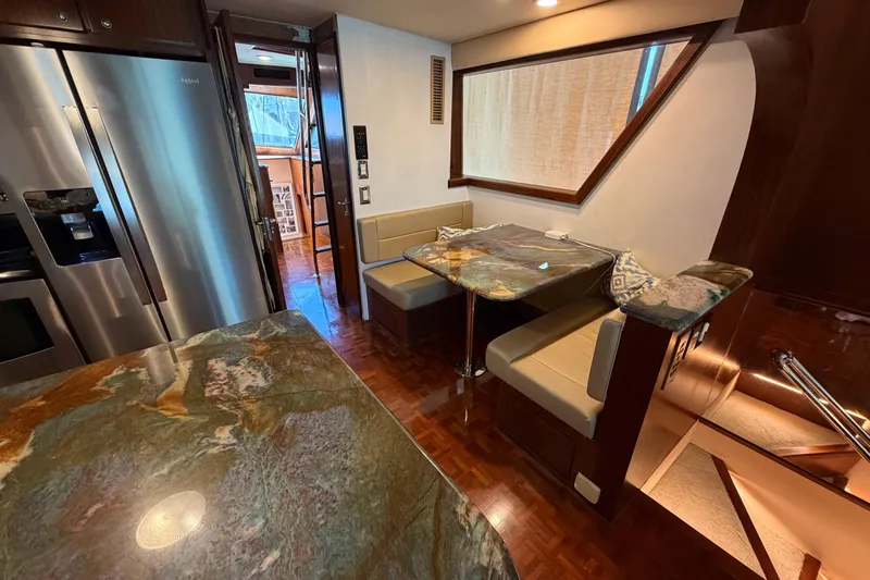  Yacht Photos Pics Luxurious 1991 Hatteras 70 Motor Yacht interior with modern kitchen and dining area.