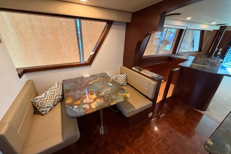  Yacht Photos Pics Interior of 1991 Hatteras 70 Motor Yacht with elegant dining area and wood finishes.