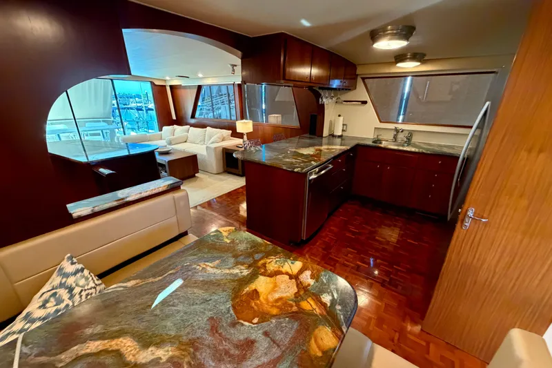  Yacht Photos Pics Luxurious interior of a 1991 Hatteras 70 Motor Yacht with modern kitchen and seating area.