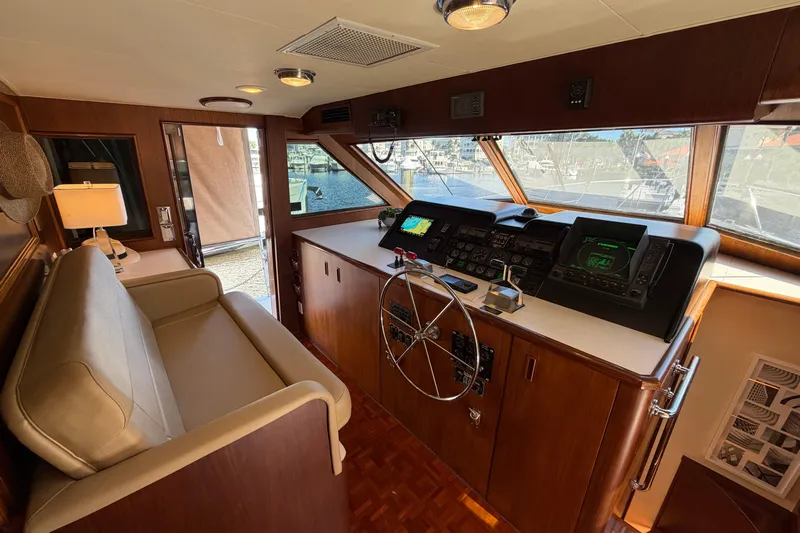  Yacht Photos Pics Interior helm of 1991 Hatteras 70 Motor Yacht with steering wheel and navigation equipment.