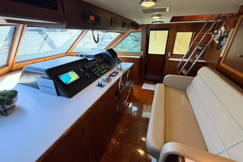  Yacht Photos Pics Interior helm of 1991 Hatteras 70 Motor Yacht with navigation equipment and seating.