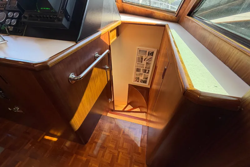  Yacht Photos Pics Interior of 1991 Hatteras 70 Motor Yacht with wooden stairs and control panel.