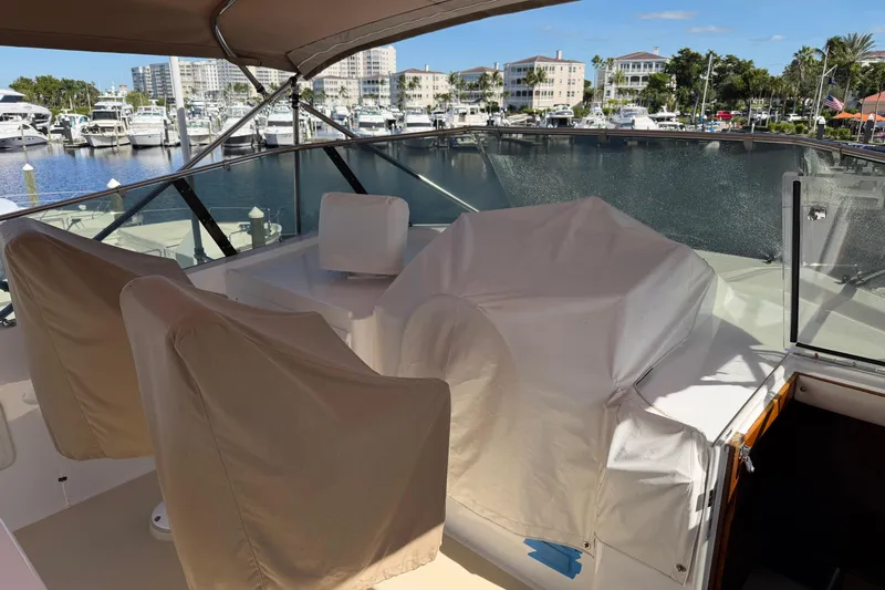  Yacht Photos Pics 1991 Hatteras 70 Motor Yacht deck with covered seating, docked at marina.