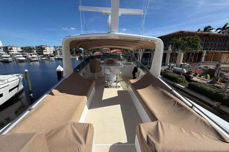  Yacht Photos Pics 1991 Hatteras 70 Motor Yacht deck with seating, docked in marina under clear blue sky.
