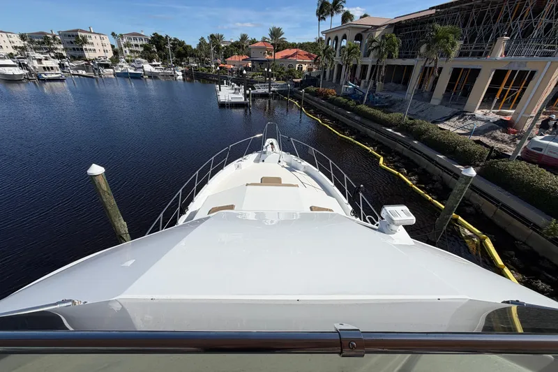  Yacht Photos Pics Bow view of 1991 Hatteras 70 Motor Yacht docked in a marina.
