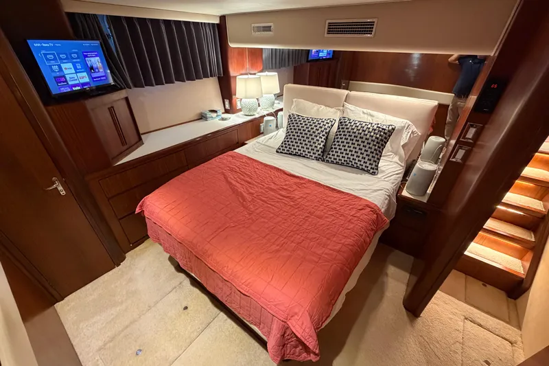  Yacht Photos Pics Bedroom interior of 1991 Hatteras 70 Motor Yacht with cozy bed and modern amenities.