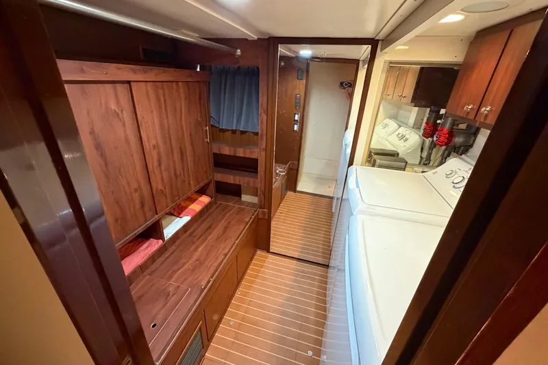  Yacht Photos Pics Interior of 1991 Hatteras 70 Motor Yacht with wood paneling and laundry area.