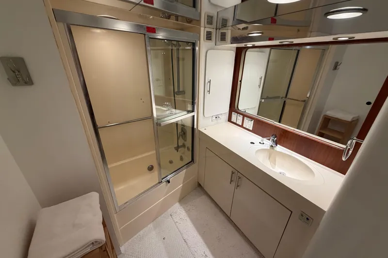  Yacht Photos Pics Bathroom interior of 1991 Hatteras 70 Motor Yacht with shower and vanity.